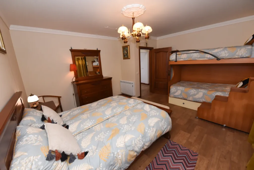 Bedroom at Villa da Rochinha in Porto da Cruz with double bed and bunk bed